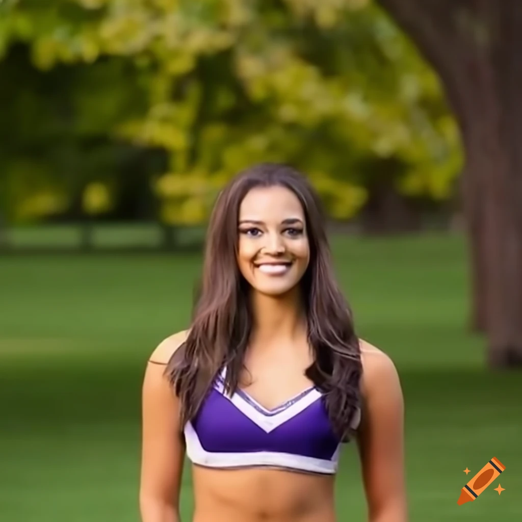 cheerleader posing by a tree