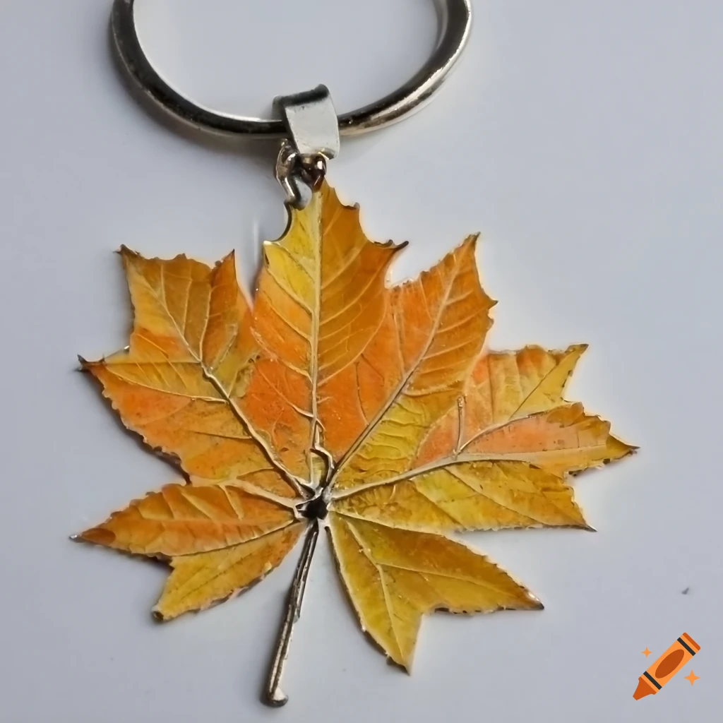 metal keychain featuring an orange autumn tree