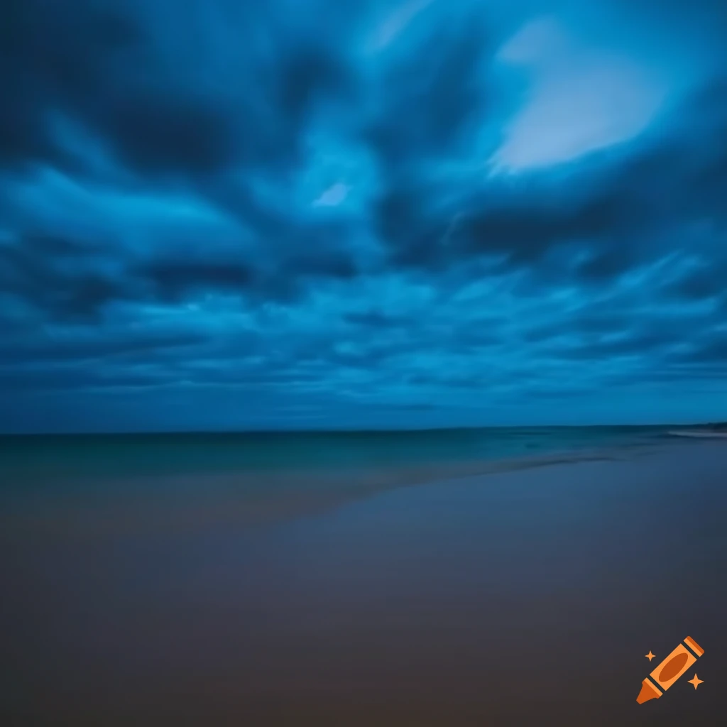 photo of a beach with a dark blue sky