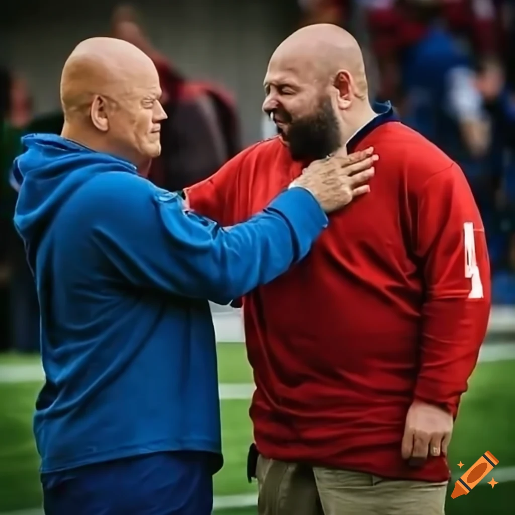 michael-chiklis-in-suit-and-coach-brian-daboll-in-blue-hoodie-shaking