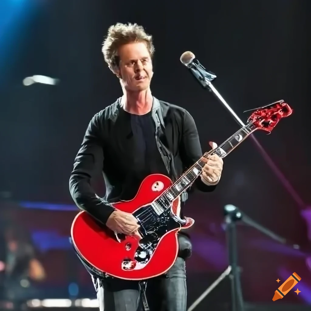 Edward Norton playing a red Gibson electric guitar in a concert