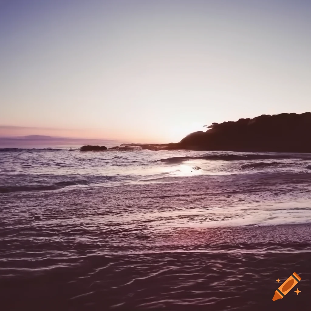 Tranquil beach with waves crashing at sunset