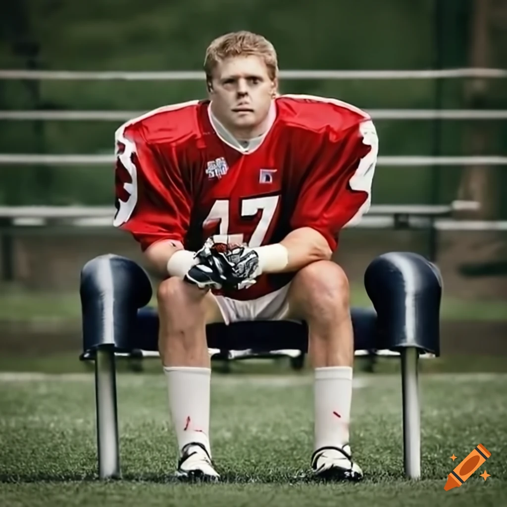 American football player sitting on the sideline bench
