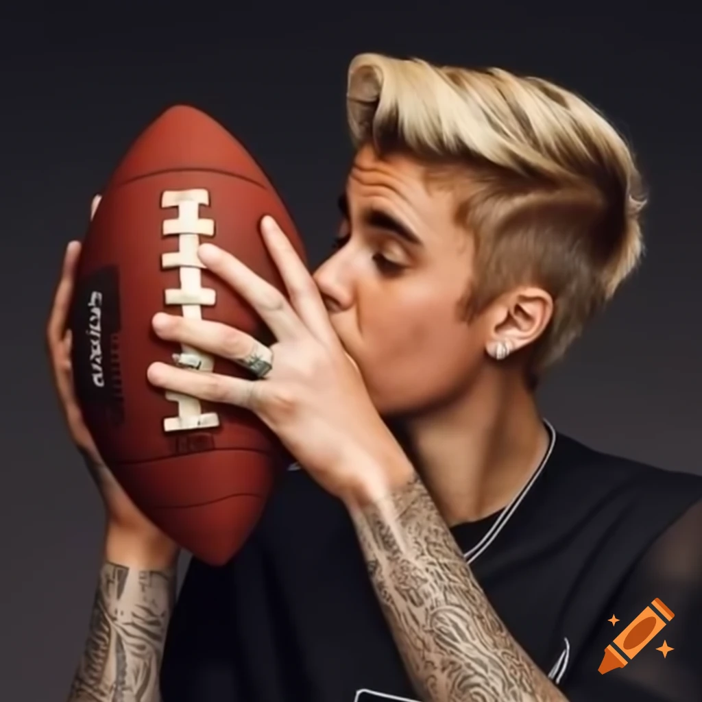Justin Bieber playfully kissing a football in the end zone